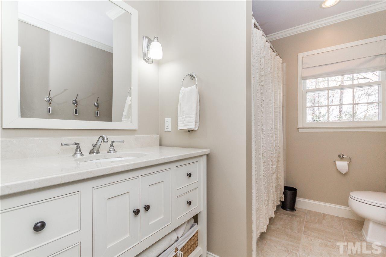2408 Ridge Road Raleigh, NC 27612 - Photo 17 of 25 a bathroom with a granite countertop sink vanity mirror and toilet