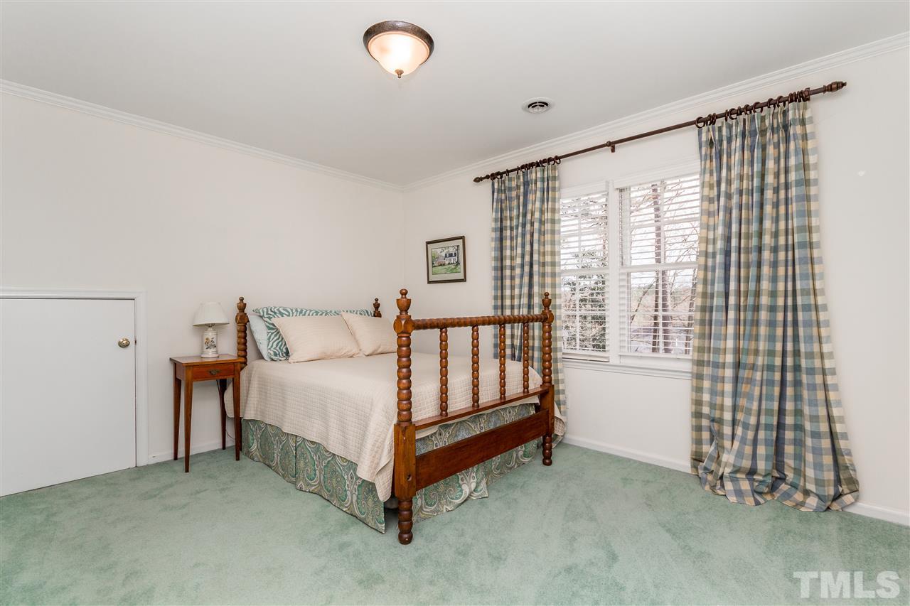 2408 Ridge Road Raleigh, NC 27612 - Photo 18 of 25 a bed sitting in a room next to a window