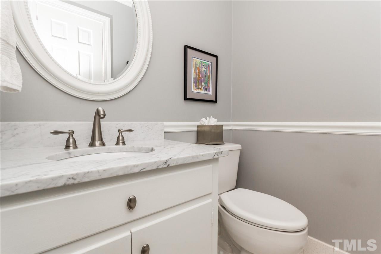 2408 Ridge Road Raleigh, NC 27612 - Photo 19 of 25 a bathroom with a granite countertop toilet a sink and mirror