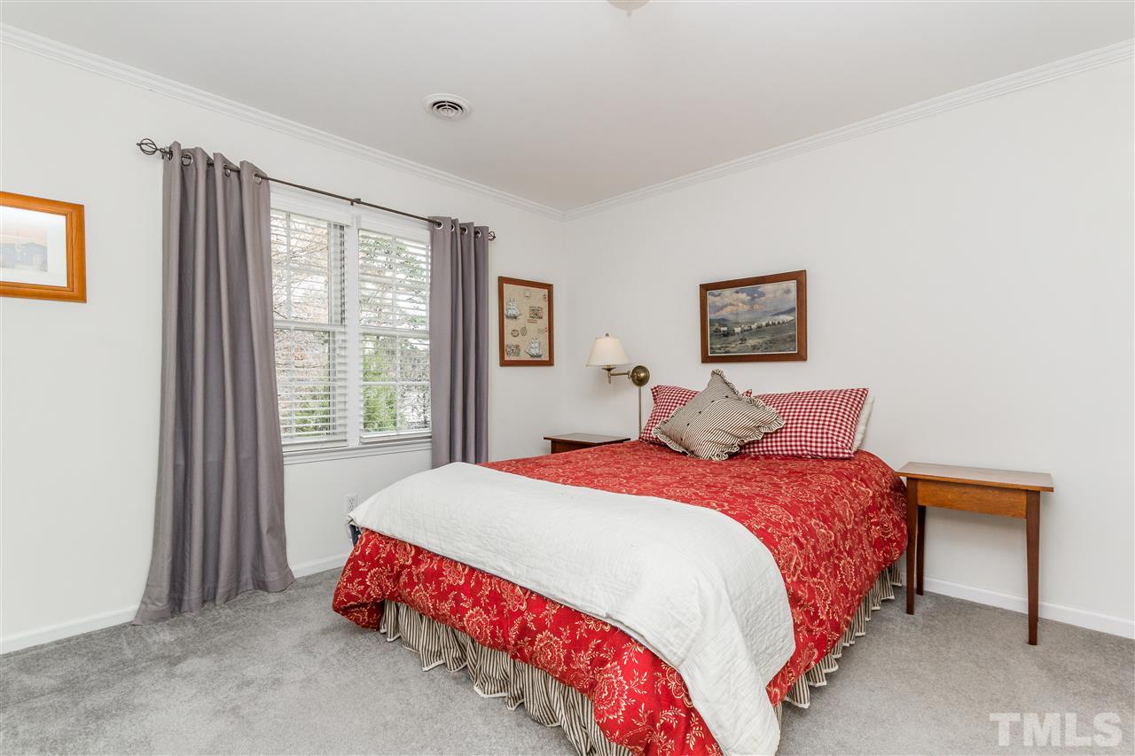 2408 Ridge Road Raleigh, NC 27612 - Photo 20 of 25 a bedroom with a bed and window
