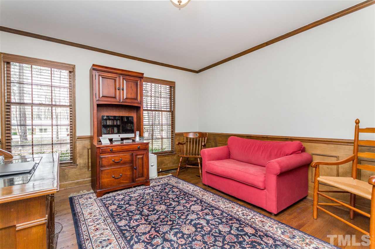 2408 Ridge Road Raleigh, NC 27612 - Photo 21 of 25 a living room with furniture a flat screen tv and a window