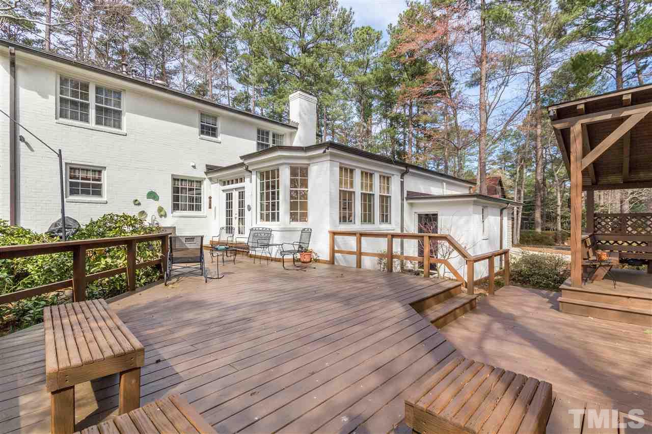 2408 Ridge Road Raleigh, NC 27612 - Photo 23 of 25 a view of a house with wooden deck and furniture