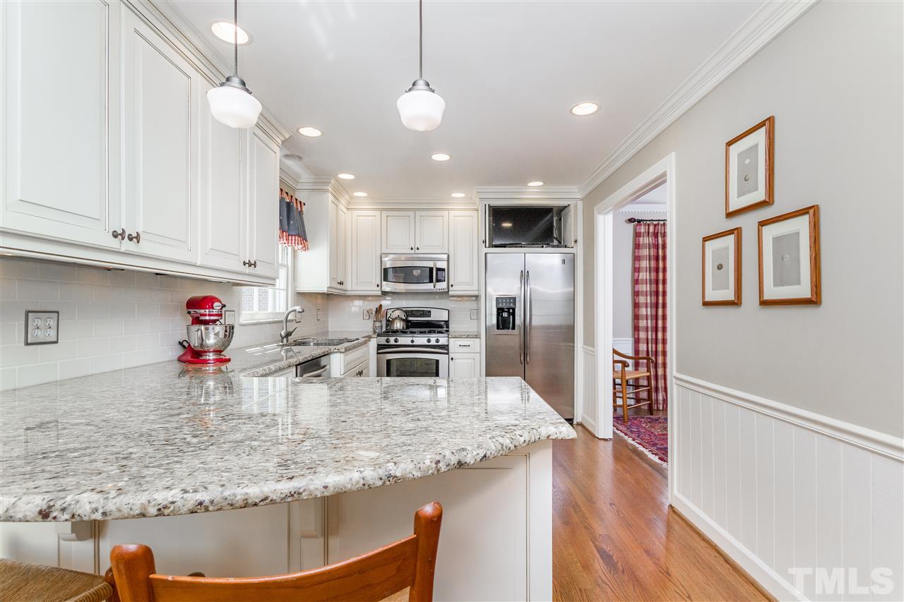2408 Ridge Road Raleigh, NC 27612 - Photo 9 of 25 a kitchen with stainless steel appliances granite countertop a sink refrigerator and cabinets
