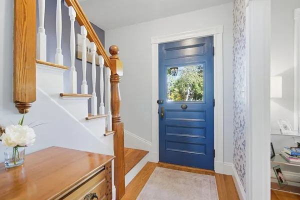 a view of hallway with furniture and a window