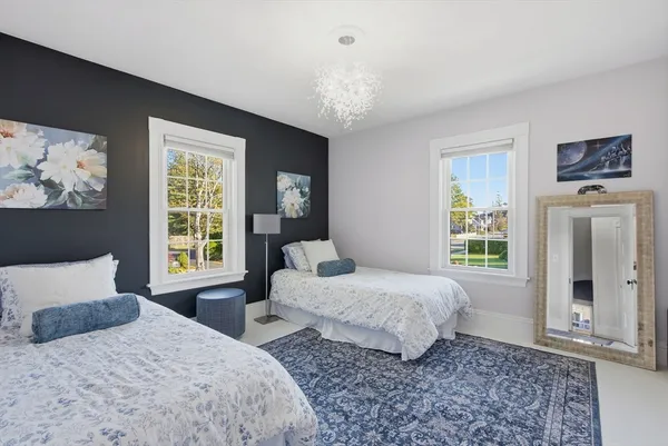 a bedroom with two beds and a window