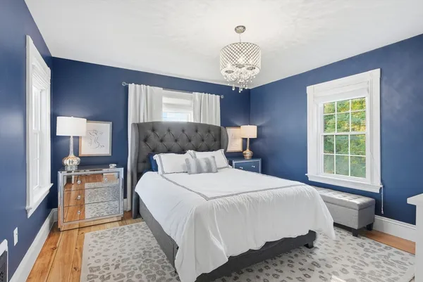 a bedroom with a large bed and a window