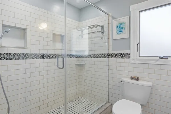 a bathroom with a toilet and a shower