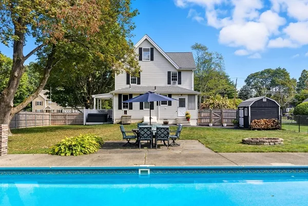 a view of a house with swimming pool and sitting area