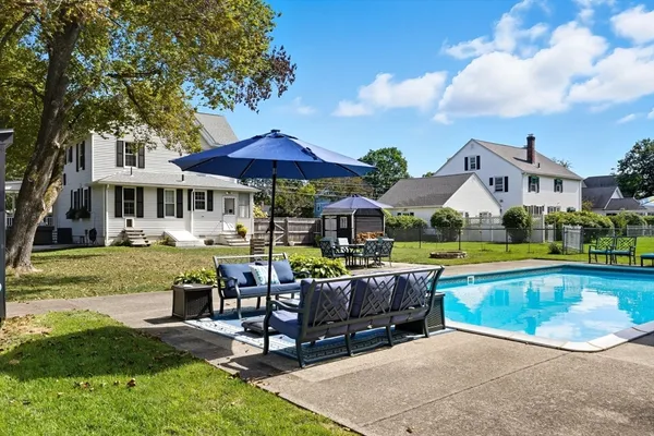a view of house with swimming pool yard and outdoor seating