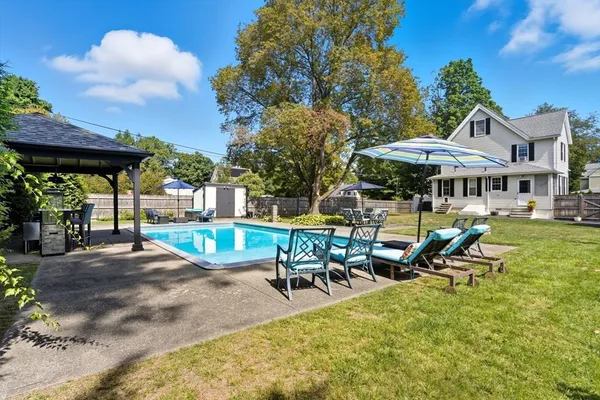 a view of a patio with table and chairs under an umbrella