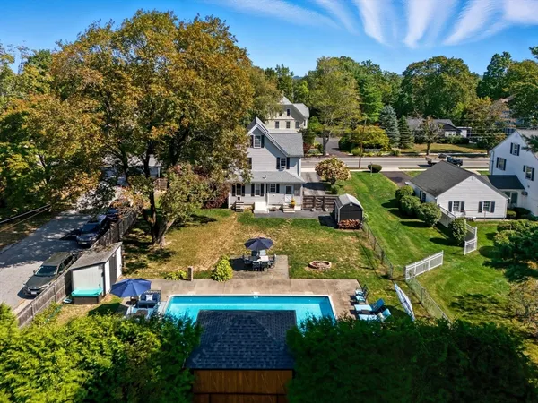 an aerial view of a house with swimming pool garden and mountain view