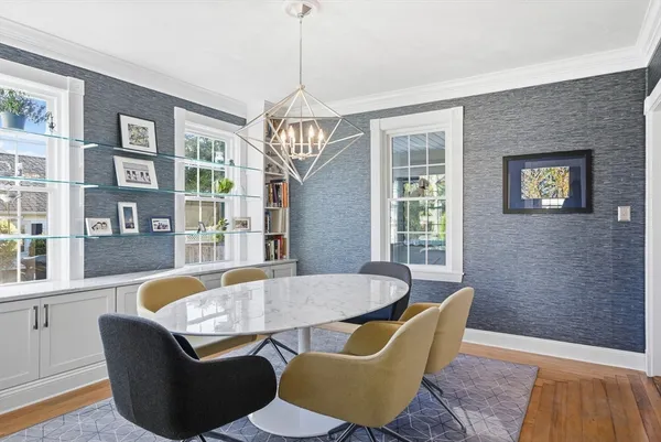 a view of a dining room with furniture wooden floor and chandelier