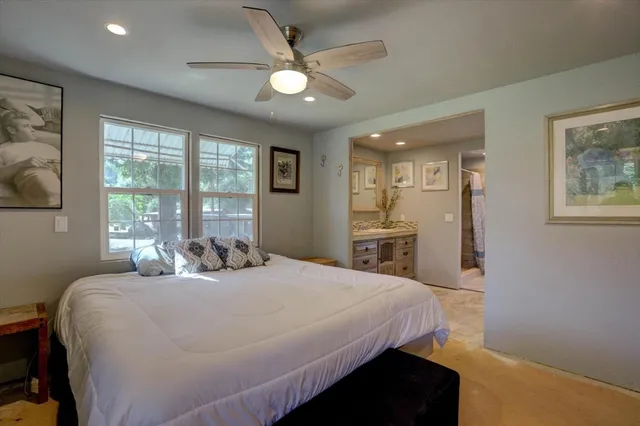 a bedroom with a bed and a flat tv screen