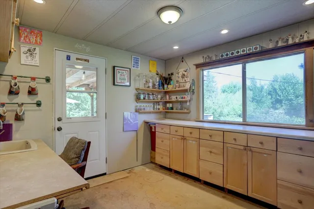 a view of a patio with furniture and a garden