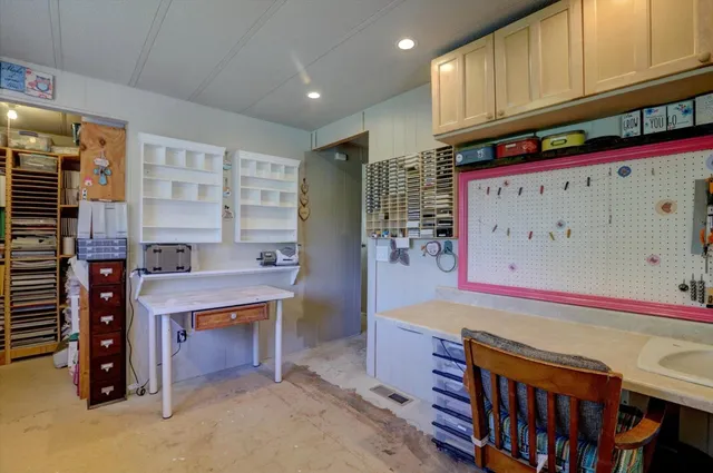 a view of a patio with table and chairs under an umbrella
