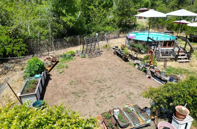 a view of a backyard with a garden and trees