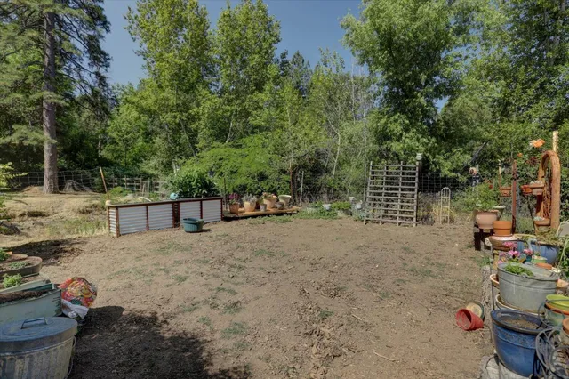 a view of a house with backyard and sitting area
