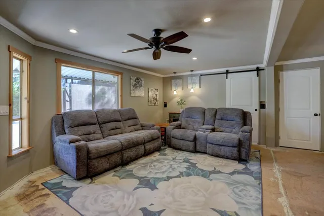 a large kitchen with stainless steel appliances a large counter top a stove and a sink