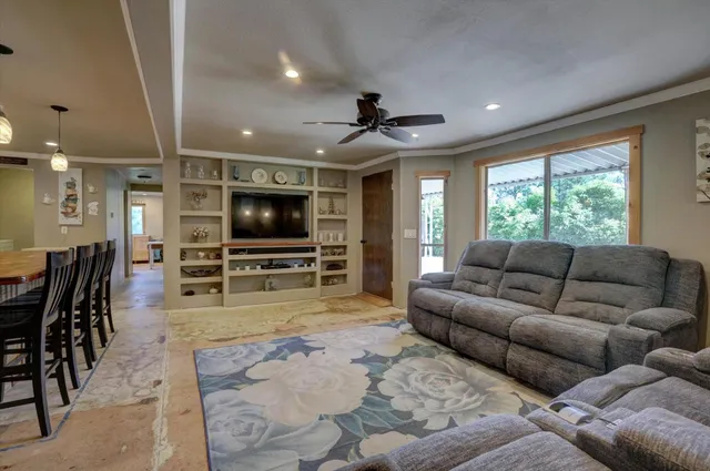 a kitchen with stainless steel appliances granite countertop a sink a stove and a refrigerator