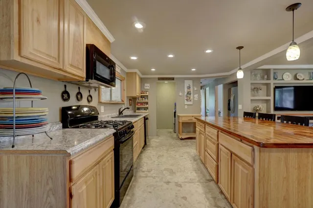 a dining room with furniture a chandelier fan and a dining table