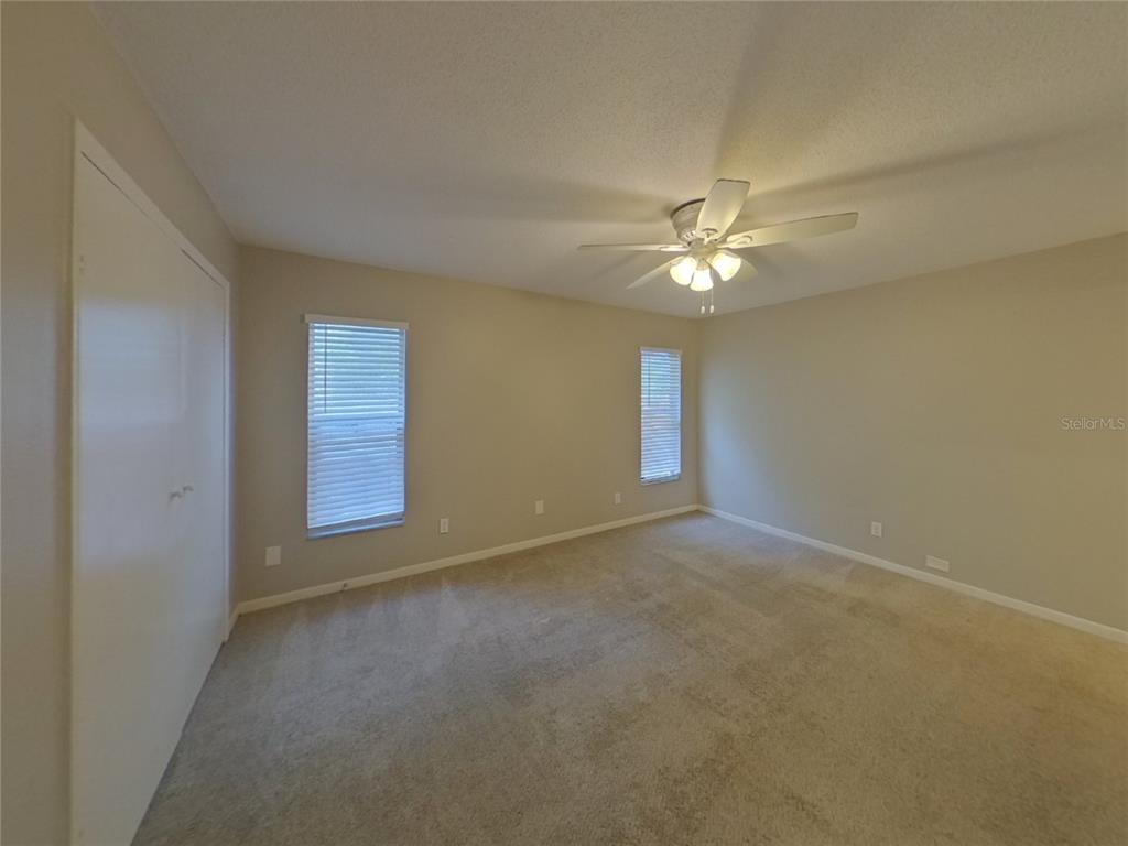 Undisclosed Address Seffner, FL 33584 - Photo 6 of 16 an empty room with windows and fan