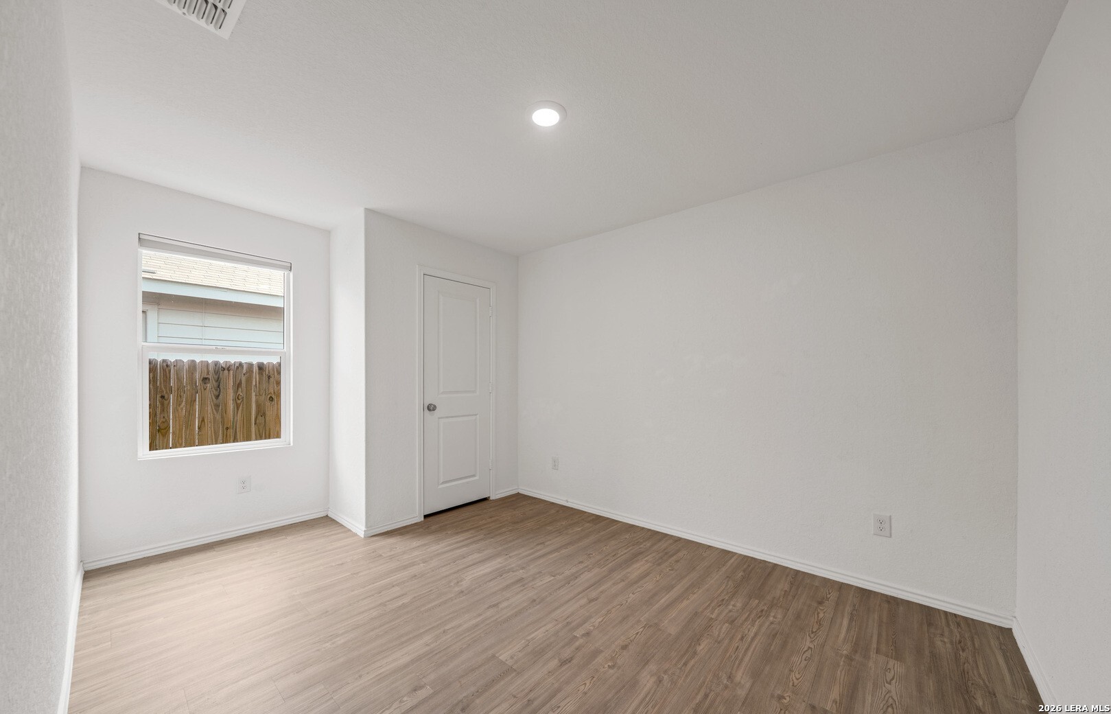 6566 Runaway Row Converse, TX 78109 - Photo 22 of 27 wooden floor in an empty room with a window