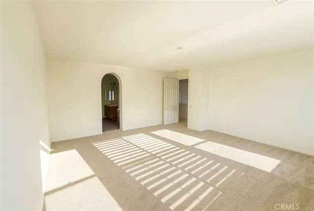 a view of a bedroom with wooden floor and bathroom
