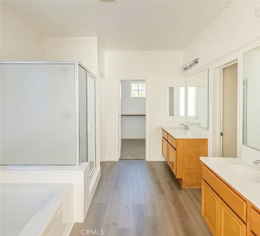 a large bathroom with a granite countertop tub a sink and a large mirror