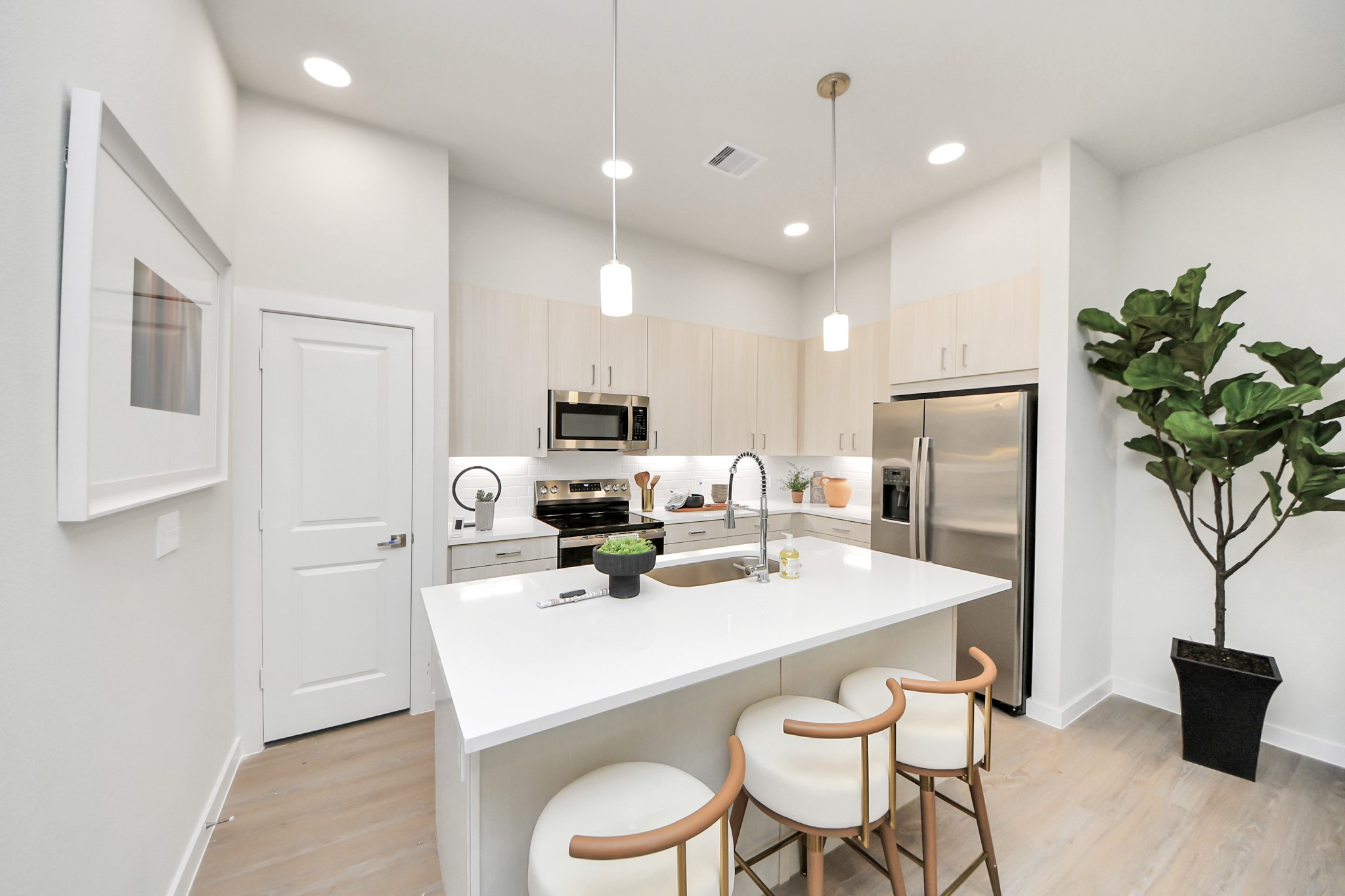 7306 Corey Rushing Lane Richmond, TX 77407 - Photo 49 of 50 a kitchen with stainless steel appliances a dining table chairs refrigerator and microwave