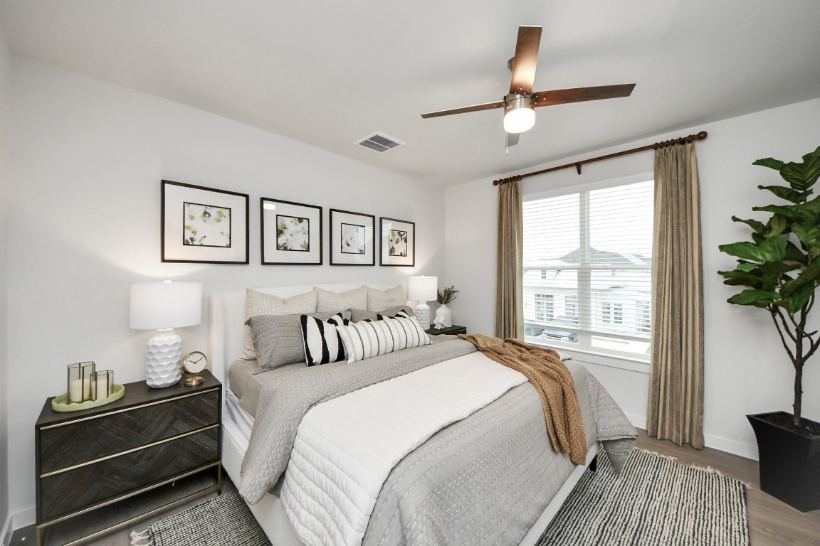 7306 Corey Rushing Lane Richmond, TX 77407 - Photo 25 of 50 a bedroom with a large bed and a potted plant