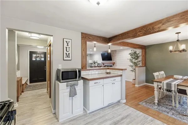 a kitchen with a sink cabinets and wooden floor