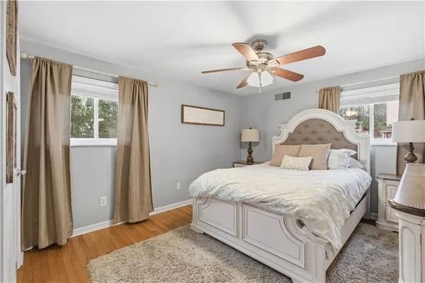 a bedroom with a bed and wooden floor