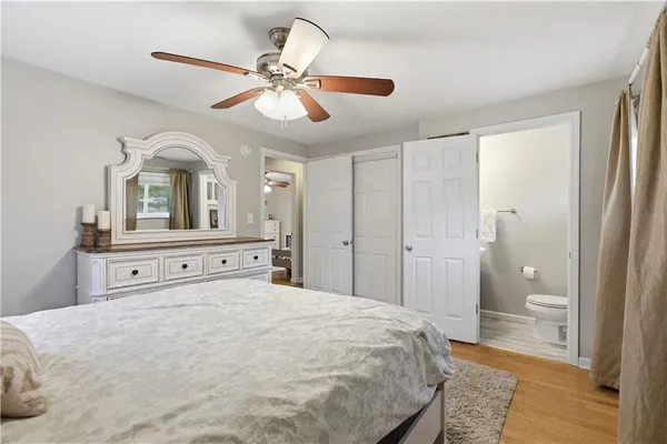 a spacious bedroom with a bed and a chandelier