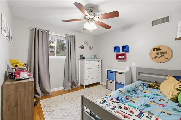 a bedroom with a bed and a dresser in it