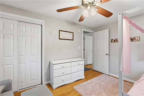 a bedroom with a bed and a ceiling fan