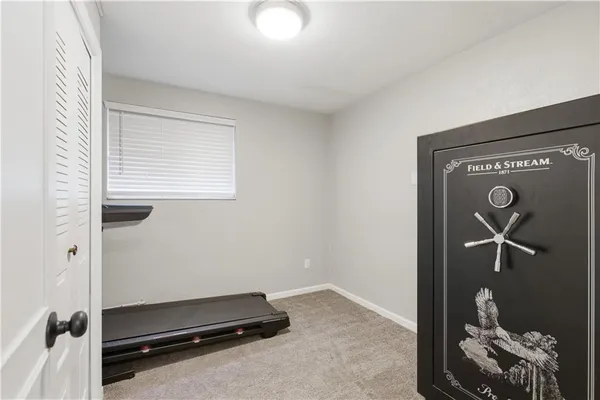 a room with gym equipment and view of living room