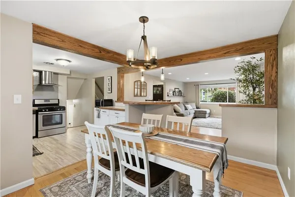 a view of a dining room with furniture wooden floor and chandelier