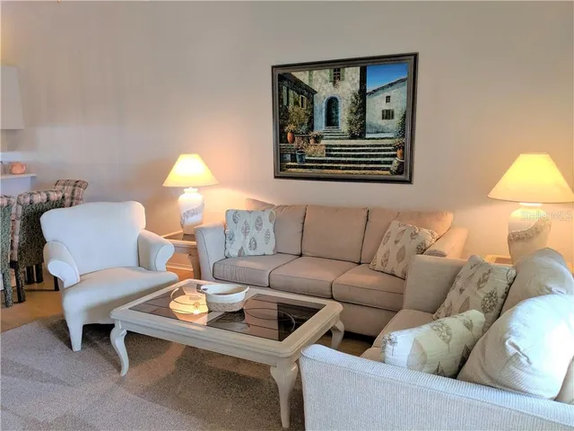 a living room with furniture and a lamp