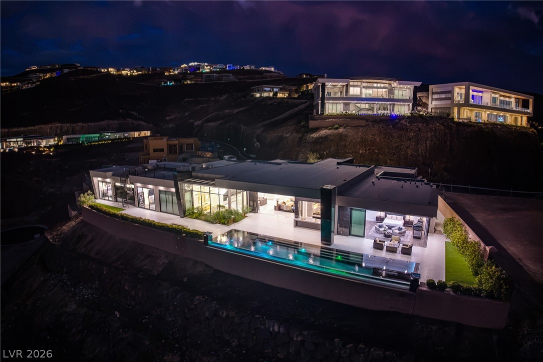 611 Cityview Ridge Drive Henderson, NV 89012 - Photo 66 of 66 Dramatic hillside architecture commands attention with a seamless transition to the modern glass-walled terrace.