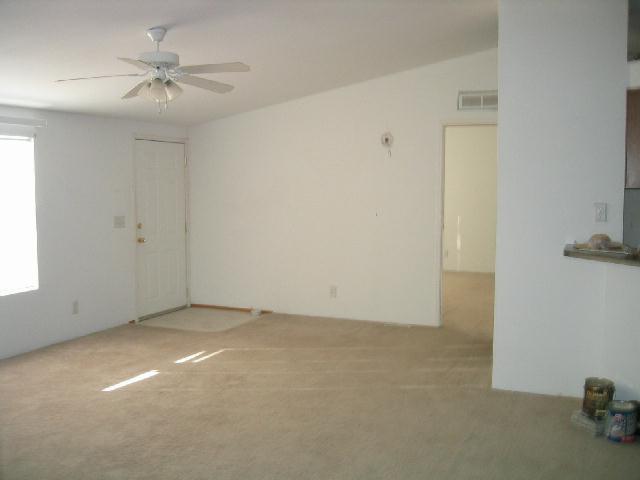 231 Hatton Road Tieton, WA 98947 - Photo 3 of 9 an empty room with a ceiling fan and a window