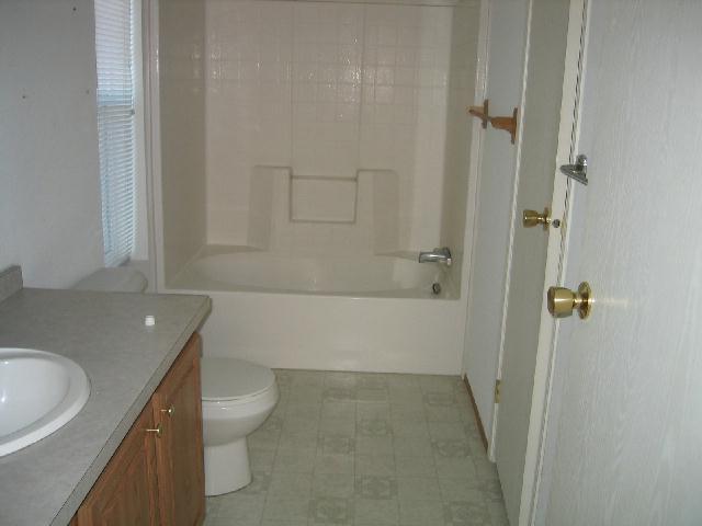 231 Hatton Road Tieton, WA 98947 - Photo 5 of 9 a bathroom with a granite countertop bathtub shower sink vanity and toilet