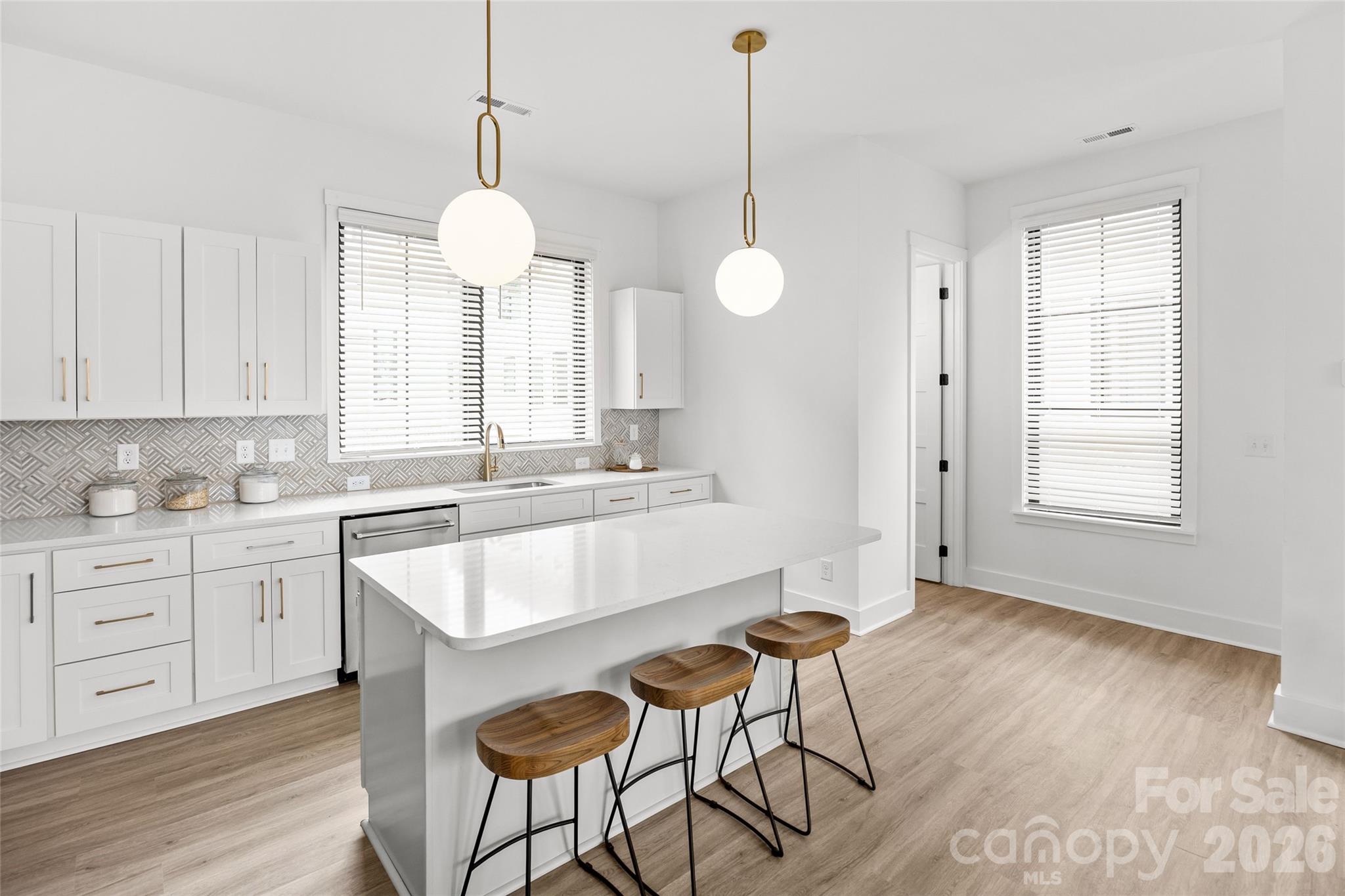4041 South Tryon Street Charlotte, NC 28217 - Photo 14 of 45 a large white kitchen with a window and a sink