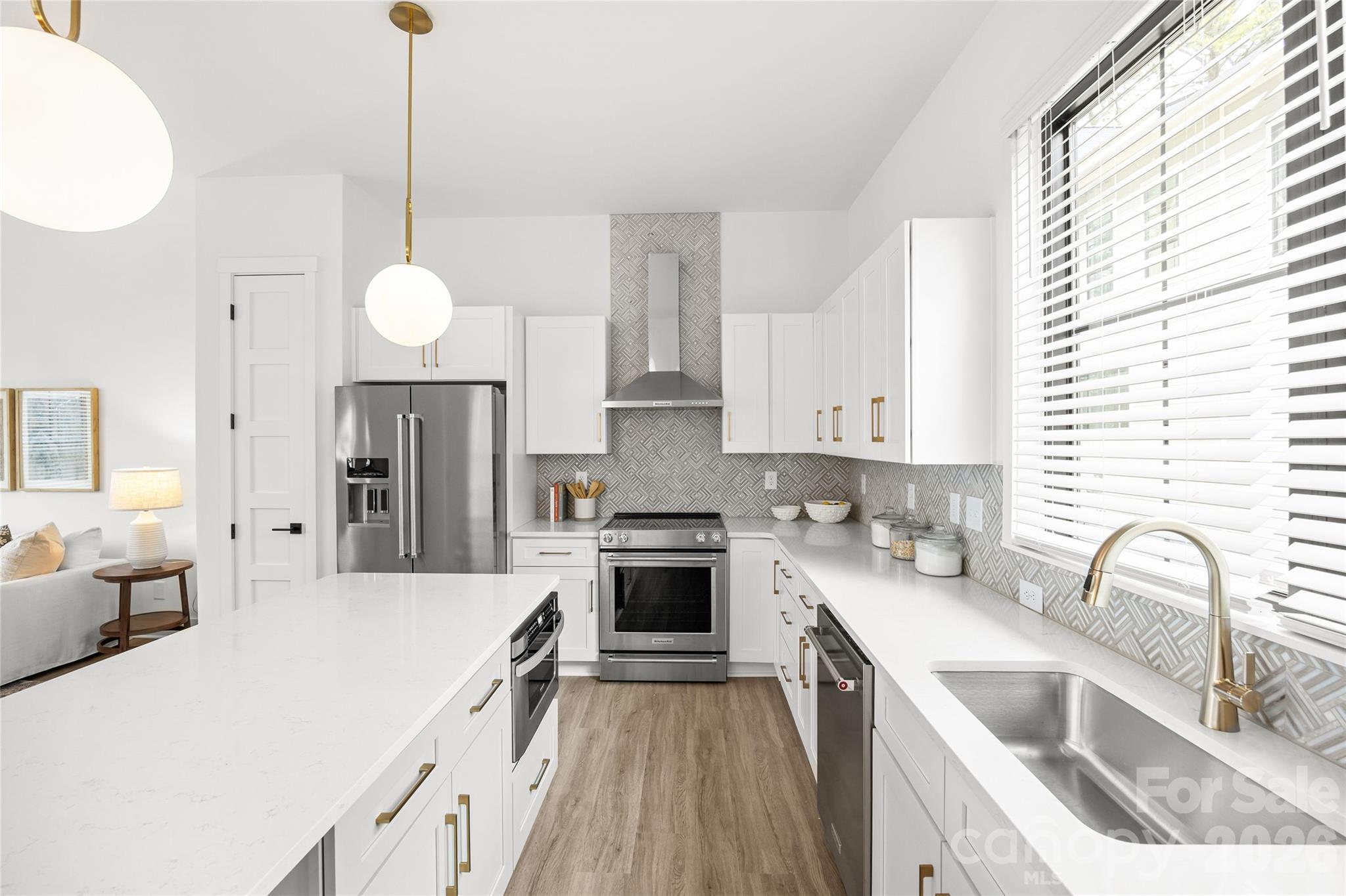4041 South Tryon Street Charlotte, NC 28217 - Photo 18 of 45 a kitchen with a sink cabinets a counter top space and stainless steel appliances