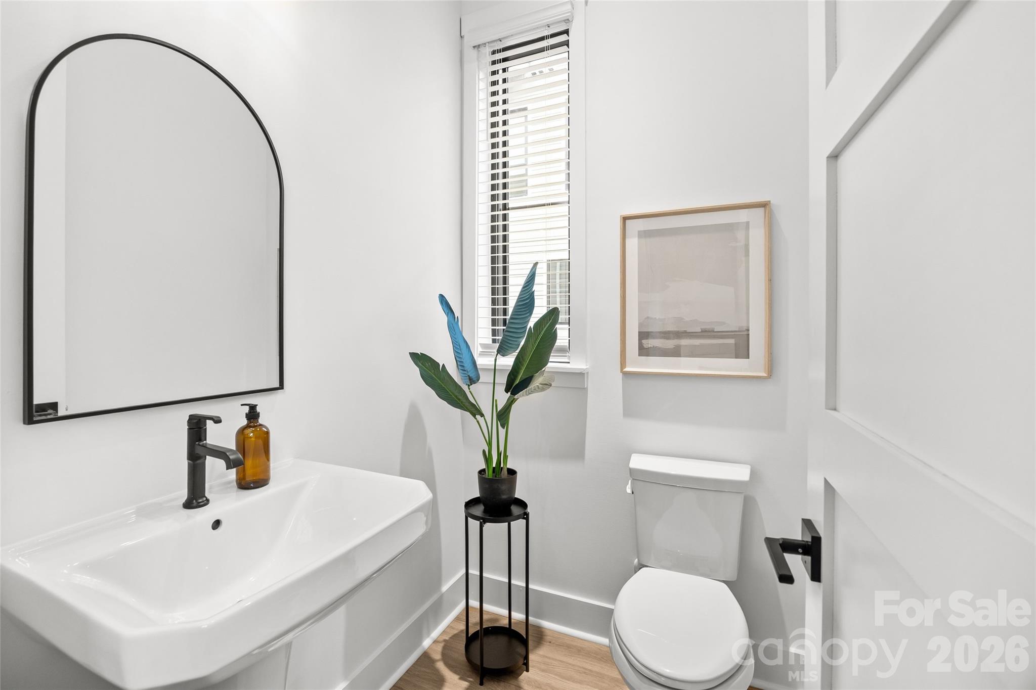 4041 South Tryon Street Charlotte, NC 28217 - Photo 22 of 45 a bathroom with a sink a toilet and a mirror