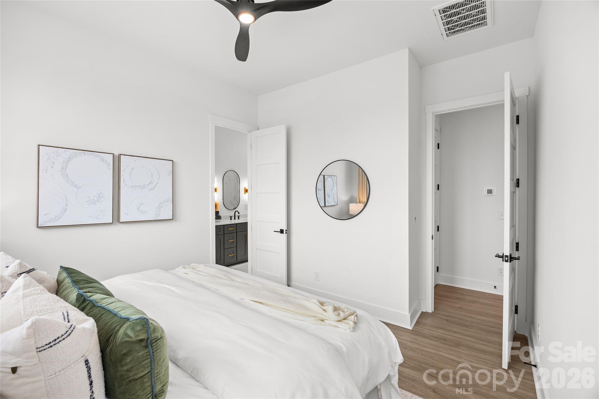 4041 South Tryon Street Charlotte, NC 28217 - Photo 34 of 45 a bedroom with a bed and wooden floor