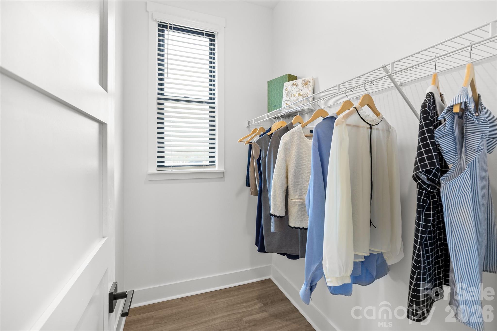 4041 South Tryon Street Charlotte, NC 28217 - Photo 36 of 45 a view of walk in closet with clothes and shoes