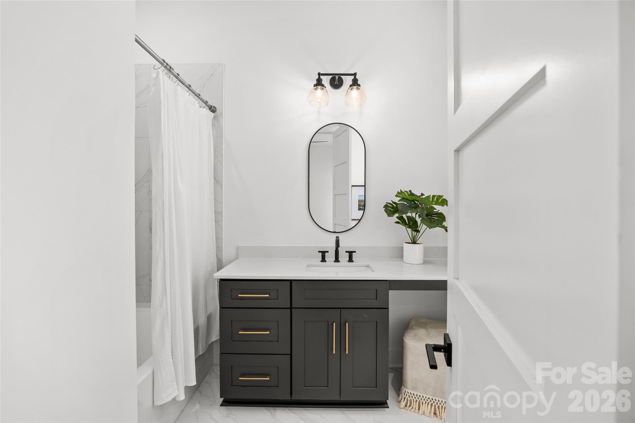 4041 South Tryon Street Charlotte, NC 28217 - Photo 42 of 45 a bathroom with a sink and a mirror