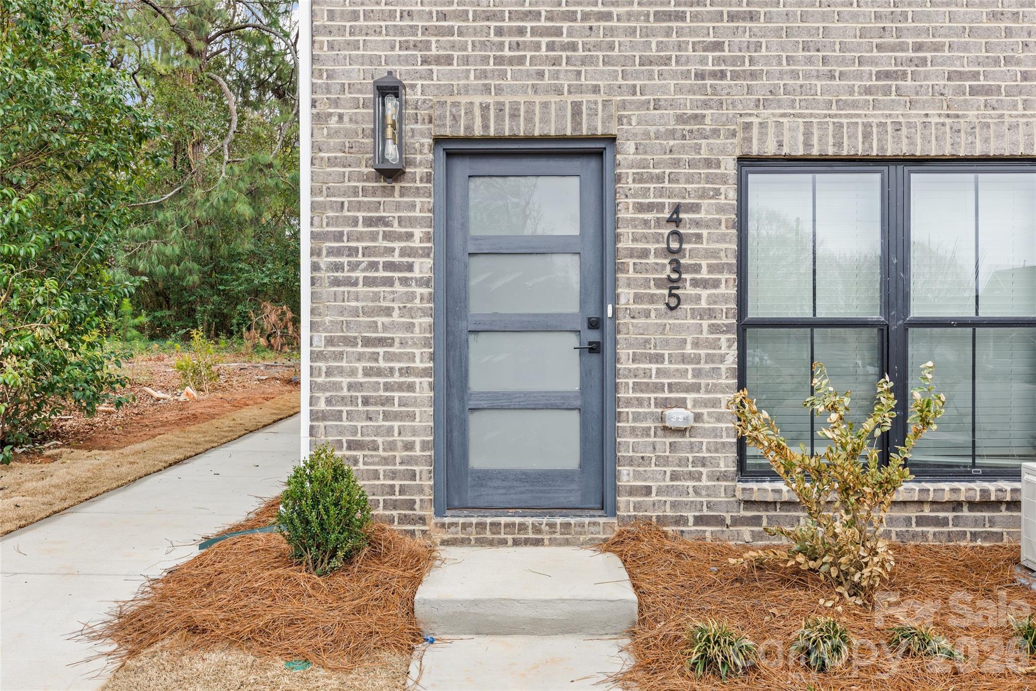 4041 South Tryon Street Charlotte, NC 28217 - Photo 7 of 45 a front view of a house with outdoor seating