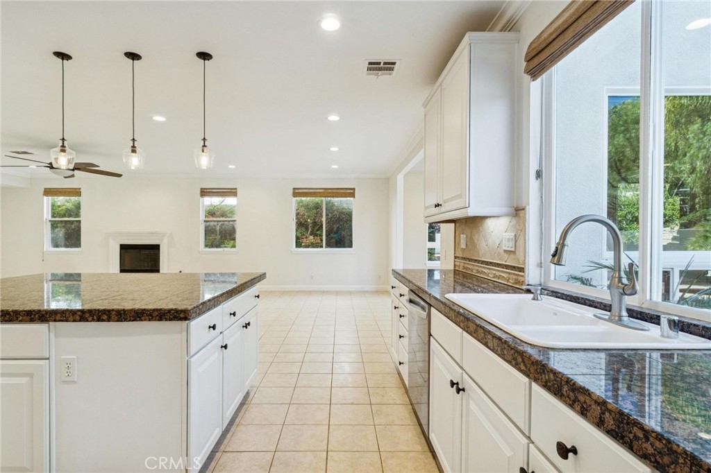 26511 Brooks Circle Stevenson Ranch, CA 91381 - Photo 12 of 65 a kitchen with granite countertop a sink a counter top space and cabinets