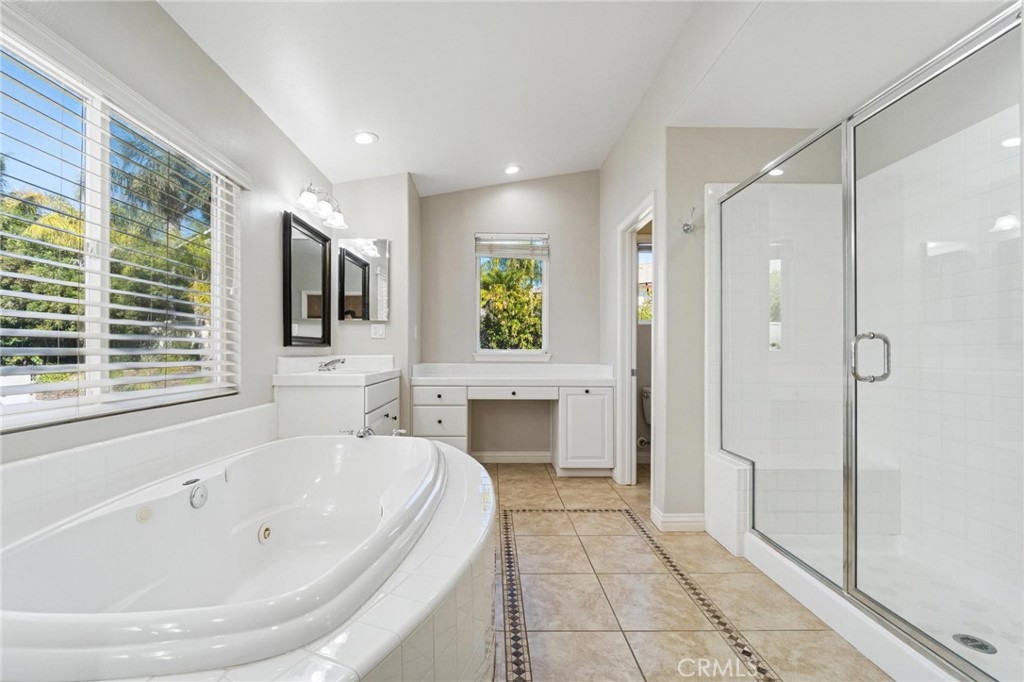 26511 Brooks Circle Stevenson Ranch, CA 91381 - Photo 30 of 65 a spacious bathroom with a bathtub and a shower